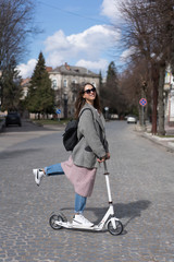 Young girl posing on a scooter