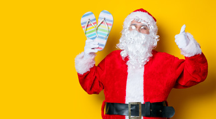 Funny Santa Claus holding flip flops