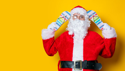 Funny Santa Claus holding flip flops