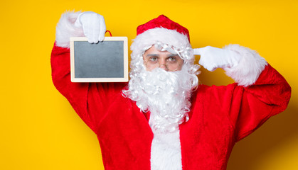 Fototapeta na wymiar Funny Santa Claus holding black board