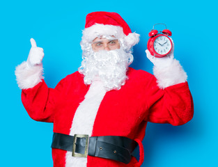 Funny Santa Claus have a fun wtih alarm clock
