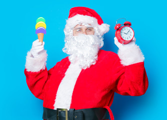 Santa Claus  with ice-cream and alarm clock
