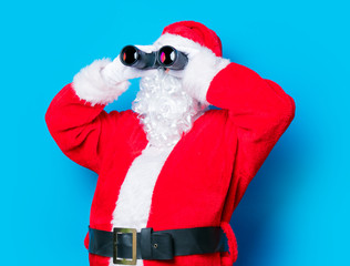 Funny Santa Claus have a fun with binoculars