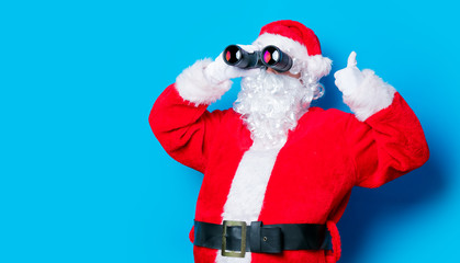 Funny Santa Claus have a fun with binoculars