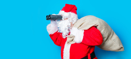 Funny Santa Claus have a fun with binoculars