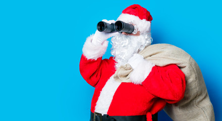 Funny Santa Claus have a fun with binoculars