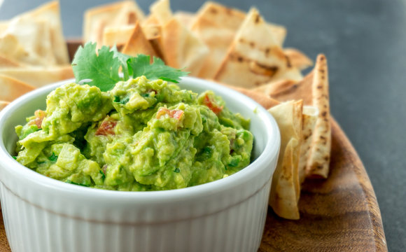 Guacamole close-up view. Guacamole is a avocado based dip, traditionally a mexican (Aztecs) dish. Healthy and easy to make at home with a few simple ingredients. Excellent as party food or at bars.