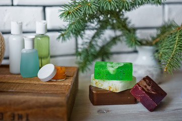 Bathroom accessories. Body care. Multi-colored natural soap, gels, shampoos, balms in vials, sea...