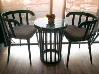 under exposure of cozy wooden table with the red orchid