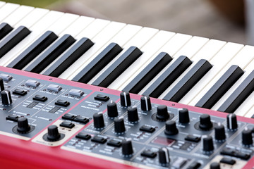 electronic synthesizer with keys, midi controller volume fader, knobs and sliders