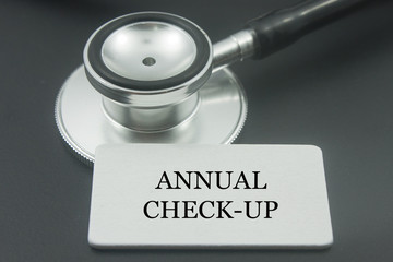 stethoscope with word annual check up isolated on black background