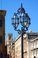 Fototapeta na wymiar Traditional wrought iron streetlight by Public Registry, Valletta, Malta.