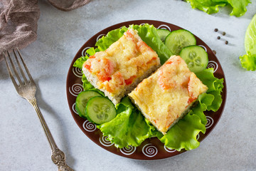 Сasserole zucchini with meat, rice, tomatoes and cheese on a gray stone background or slate.