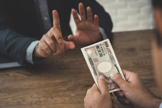 Businessman rejecting money, Japanese yen banknotes - anti bribery and corruption concepts
