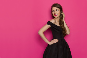 Smiling Elegant Woman In Black Dress Is Looking Away