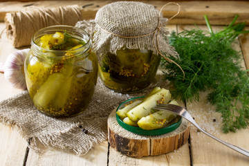 Marinated cucumbers gherkins. Marinated pickles with mustard and garlic on the kitchen table.