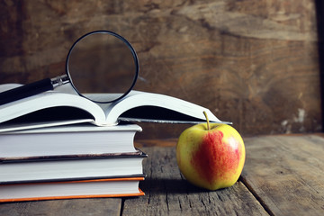 education book apple and magnifying glass