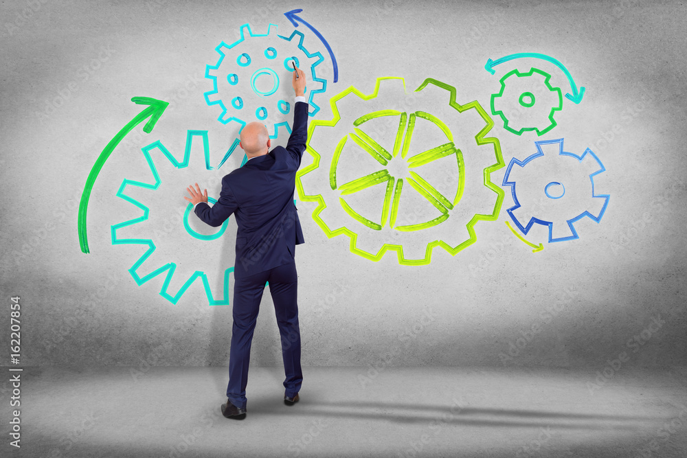 Aufkleber businessman in front of a wall with a cogwheel interface setting with different colors - technology 