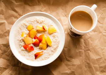 Oatmeal with peach and coffee for breakfast