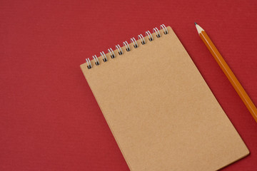 Top view of open spiral blank notebook with pencil on wood paper background. Open vintage notebook. Empty notebook paper for text with  pencil . office concept top view.Copy space. Space for text.