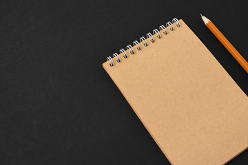 Top view of open spiral blank notebook with pencil on wood paper background. Open vintage notebook. Empty notebook paper for text with  pencil . office concept top view.Copy space. Space for text.