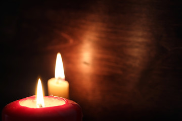 Burning candle flame in the dark