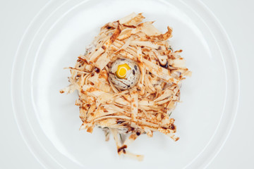 Salad in the form of a nest and decorated with quail eggs.
