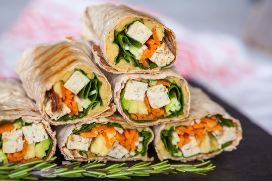 Healthy vegan tofu tortilla wraps with tofu and vegetables. Love for a healthy raw food concept.