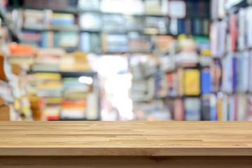 Wood table top on blurred book store interior background