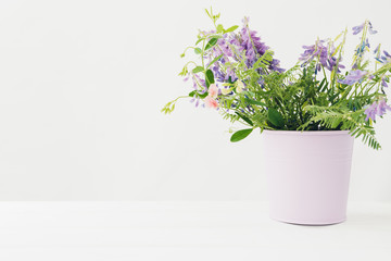 bouquet of pink  flowers in vase on white table. Empty space for text