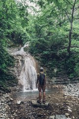 Hiker Has Reached The Destination And Enjoying View Of Waterfall And Beauty Unspoilt Nature. Contemplation Adventure Concept