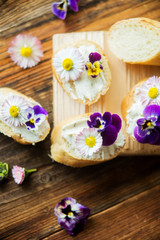 Fototapeta na wymiar Canapes with avocado paste and edible flowers
