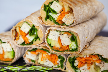 Healthy vegan tofu tortilla wraps with tofu and vegetables. Love for a healthy raw food concept.