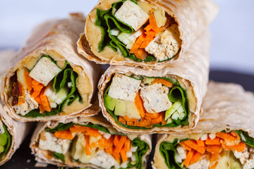 Healthy vegan tofu tortilla wraps with tofu and vegetables. Love for a healthy raw food concept.