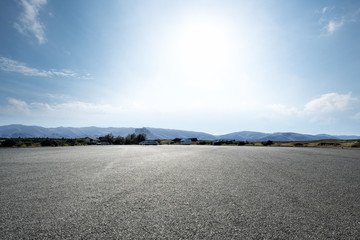 empty road near grassland with blue sky