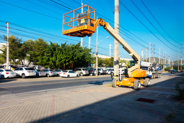 Lifting boom lift in construction site.