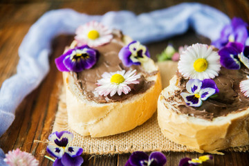 Sweet berry bruschetta with chocolate nut butter,mint and sliced almonds on the white vintage dish