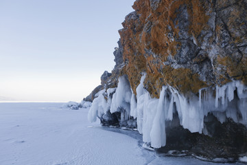 Icicles in Oltrek island rock. Lake Baikal winter landscape