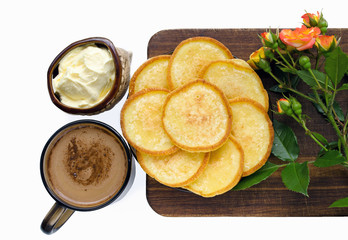 Homemade breakfast - golden pancakes with sour cream and coffee.