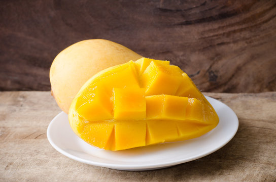 Ripe mango fruit on white dish ready to eating