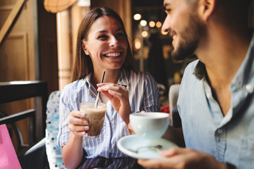 Young attractive couple on date in coffee shop