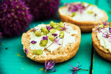 Closeup of flowering chives with shallow depth of field and focus concentrated on flower in the foreground