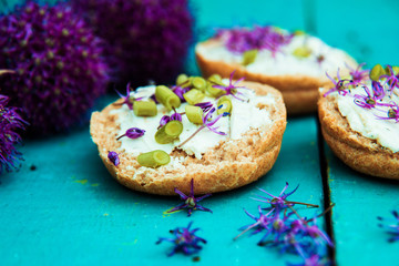 Closeup of flowering chives with shallow depth of field and focus concentrated on flower in the foreground