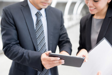 Businesswoman and businessman using  tablet pc
