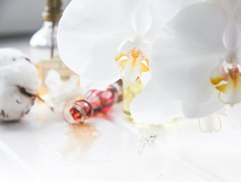 perfume and flowers cotton and white Orchid on white wooden table