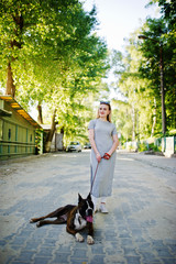 Girl with dog pit bull terrier on a walk.