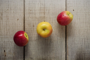 Apple lined up on wooden.