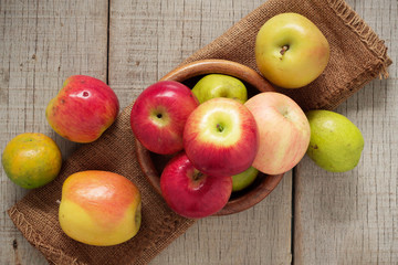 Apples in a bowl on wooden.