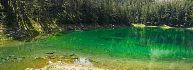 Horizontal panorama of famous green lake in Austria