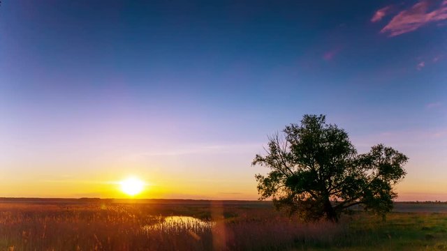 4K .Beautiful sunset landscape with stream, clouds and sun. Time lapse without birds